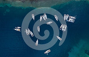 Aerial view of a much chaotically standing boats in a bay at sunset, Croatia, coastline with azure water and green trees