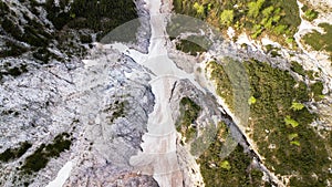 Aerial view of the mudflow with snow high in the Alpine mountains, Top view