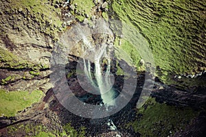 Aerial view of Mulafossur waterfall in Gasadalur village in Faroe Islands, North Atlantic Ocean. Photo made by drone from above.