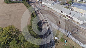 Aerial view of multiple antique restored steam engines in a train yard steaming up blowing smoke