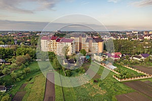 Aerial view of multistory apartment buildings in green residential area