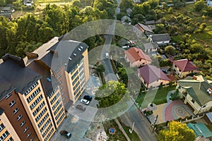 Aerial view of multistory apartment buildings in green residential area