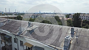 Aerial view of multistory apartment buildings in green residential area. Stock footage. Flying over the roofs of old