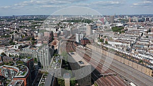 Aerial view of multitrack railway line, Victoria Light Maintenance Depot and surrounding housing estate. London, UK