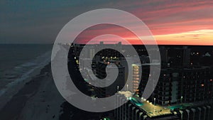 Aerial view of Myrtle Beach coastline and buildings from drone at sunset, South Carolina