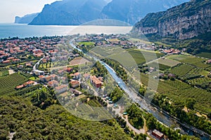 Aerial view on Nago Torbole city and Sarca River.