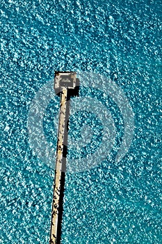 Aerial view of the Naples, Florida, pier jutting into the turquoise blue water of the Gulf of Mexico, taken from an airplane . photo