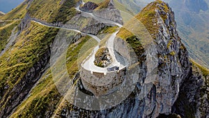 Aerial view of a narrow winding road at the top of a rocky mountain