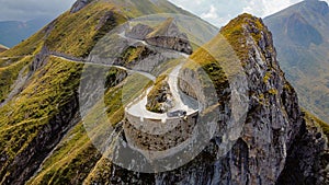 Aerial view of a narrow winding road at the top of a rocky mountain