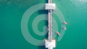 Aerial view of natural clear blue sea with sea floating bridge and boat.