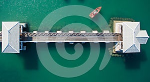 Aerial view of natural clear blue sea with sea floating bridge and boat