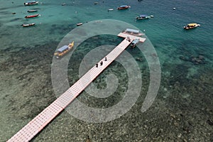 Aerial view of natural clear blue sea with sea floating bridge and boat, Perhentian Kecil Island., Beautiful destination place