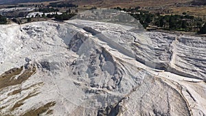 Aerial view of natural dried up white baths. Travertines of Pamukkale in Turkey