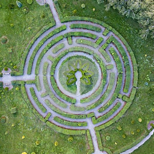 Aerial view of a natural labyrinth round shape in the garden. Photo from the drone.