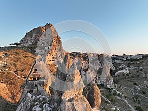 Aerial view of natural rock formations in the sunset, valley with cave houses in Cappadocia, Turkey. Natural landscape