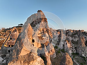 Aerial view of natural rock formations in the sunset, valley with cave houses in Cappadocia, Turkey. Natural landscape