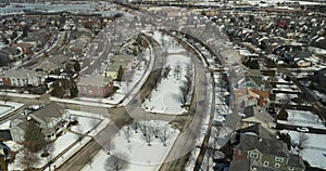 Aerial view of a neighborhood with homes and townhomes in winter