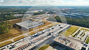 Aerial view of new big factory complex for producing and shipping of industrial equipment. Global manufacture concept