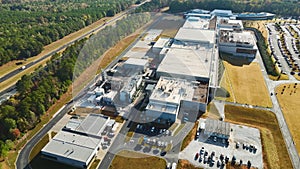 Aerial view of new big factory complex for producing and shipping of industrial equipment. Global manufacture concept