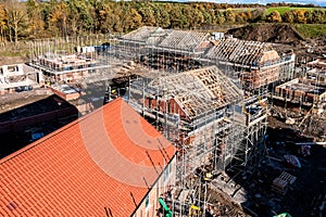 Aerial view of new build homes on a building site with exposed roof