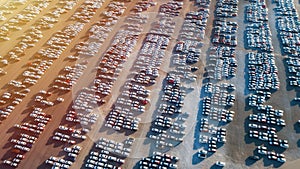 Aerial view of big parking lot of new cars. Automobile factory