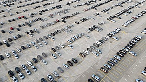 Aerial view of new cars lined up parking outside factory on car factory background. Industrial concept