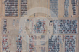 Aerial view of new cars at parking port in automobile factory.