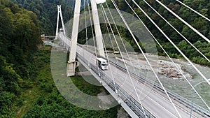 Aerial view of new concrete bridge with highway and driving white truck, transportation of goods concept. Stock footage