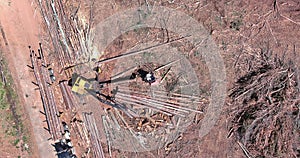 Aerial view of new construction plase on tree removal crane operator loading logs to truck