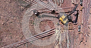 Aerial view of new construction plase on tree removal crane operator loading logs to truck