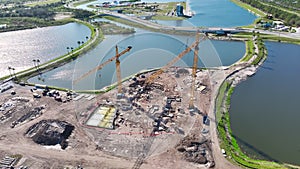 Aerial view of new developing residense in american city suburbs. Tower crane at industrial construction site. Concept