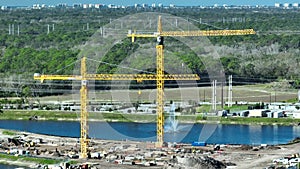 Aerial view of new developing residense in american city suburbs. Tower crane at industrial construction site. Concept