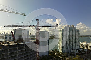 Aerial view of new developing residense in american urban area. Tower cranes at industrial construction site in Miami photo