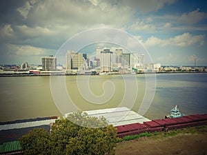 Aerial view New Orleans downtown and tugboat pushing barge