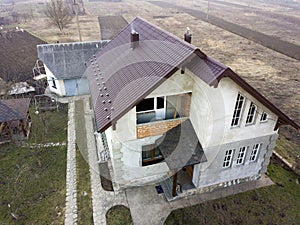 Aerial view of new residential house cottage with shingle roof