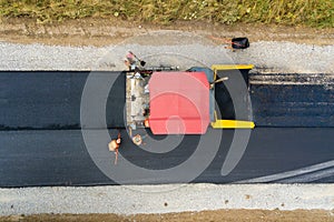Aerial view of new road construction with asphalt laying machinery at work