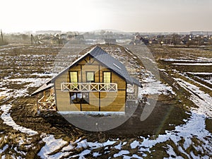 Aerial view of new wooden ecological traditional house cottage of natural lumber materials with steep shingle roof under