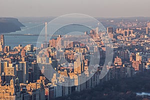 Aerial view of the New York cityscape and George Washington Bridge at a sunrise