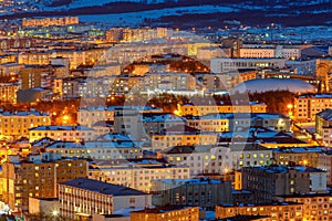 Aerial view of the night city. Cityscape with many buildings.