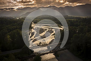 Aerial view of the Nooksack River during a dramatic summer sunrise.