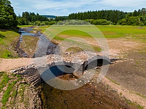 Aerial view of a normally submerged bridge at a near empty reservoir during a heatwave photo