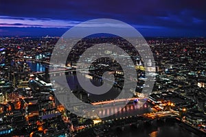 Aerial view of north east part of London, in evening. St Pauls Cathedral visible over river Thames