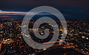 Aerial view of north east part of London, in evening. St Pauls Cathedral visible over river Thames