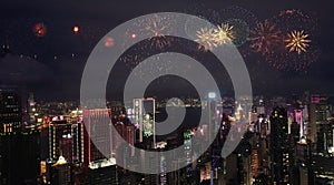 Aerial view of numerous bright fireworks explode in the sky