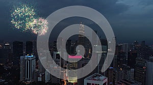 Aerial view of numerous bright fireworks explode in the sky