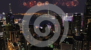 Aerial view of numerous bright fireworks explode in the sky