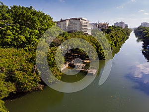 Aerial view o Marapendi canal in Barra da tijuca on a summer day. There is wooden dock, with green vegetation can be