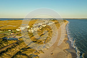 Aerial view of Oak Island North Carolina coast line. Sand dunes and houses in view.