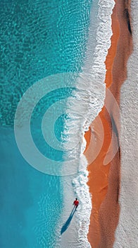 Aerial view on the ocean with blue clear water with corals, sandy beach with man walking