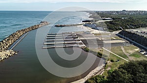 Aerial view Ocean Reef boat harbour Perth Western Australia seaside coast waves rolling onto shore and stand up paddle boarders b